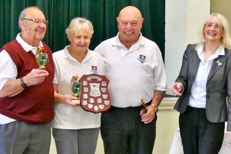 Usk SMBC's (from left) Ralph Berry (skip), Pat Cullimore (lead), and Phil Radley (2) receiving their triples champion trophies from MSMBA chair Philomena Vaughan. Photo: Colin Berg 