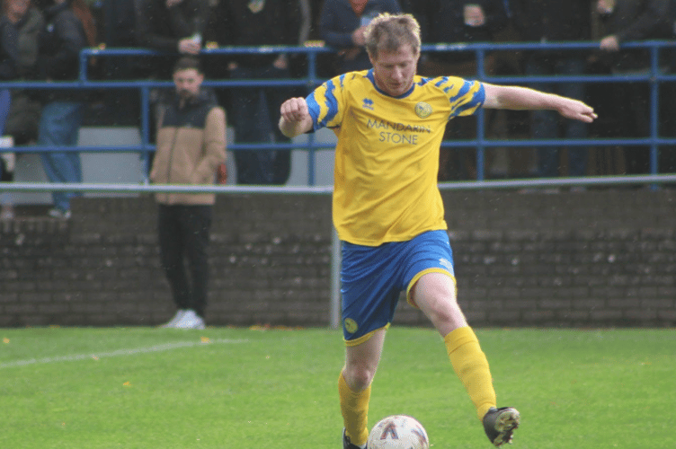A Monmouth player presses forward