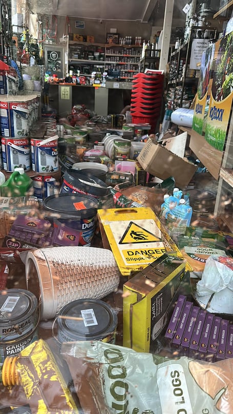 An aisle covered with flood damaged stock at Handyman House