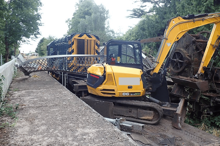 The loaded digger pulled down the St Mary's Halt footbridge on the Dean Forest Railway