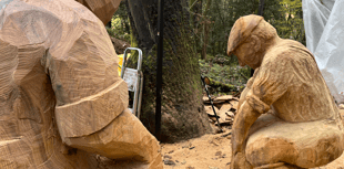Wood carver creates life-size stone mason sculptures from felled oak 