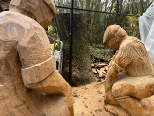 Wood carver creates life-size stone mason sculptures from felled oak 