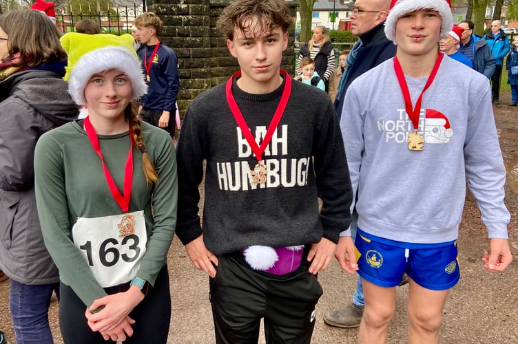 Santa Fun Run winner Will Lodick (centre) with Lily Henshilwood second, and Zach Mason third