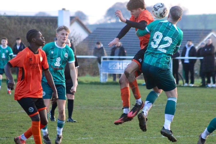 Heads you win! Players jump for the ball in Saturday's Rogerstone v Monmouth clash. Photo: James Townley