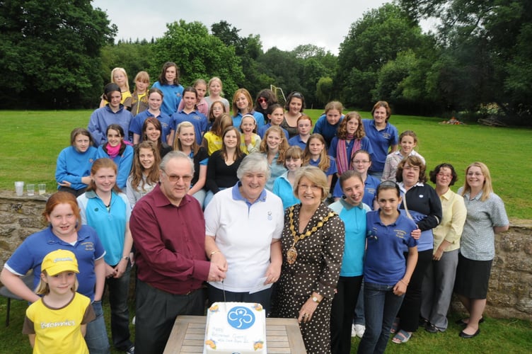 Gerry with her husband David and Sue White with past and present brownies and guides from Monmouth