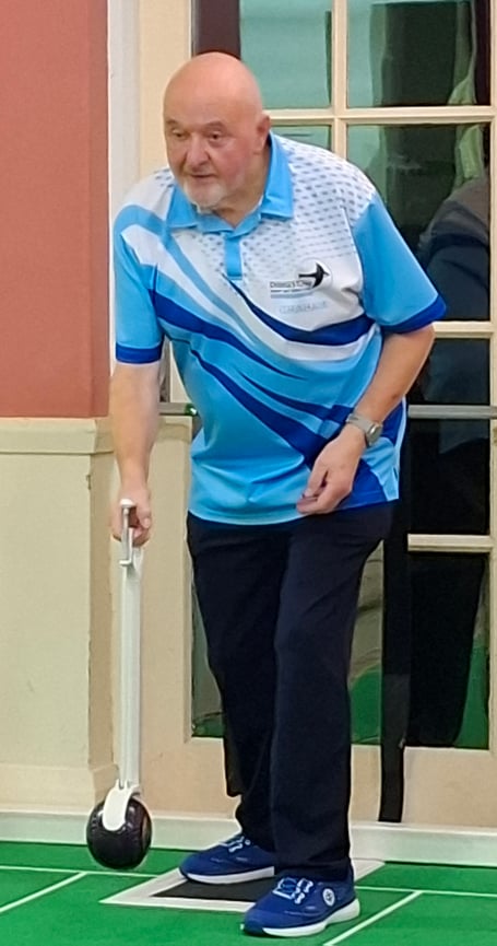 Graham Holder of Dingestow shows how effective a bowling arm can be for players who have difficulty bending to bowl. Photo: Haydn Holder