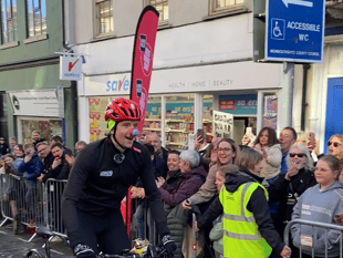 Greg James cycles into town on tandem for Comic Relief