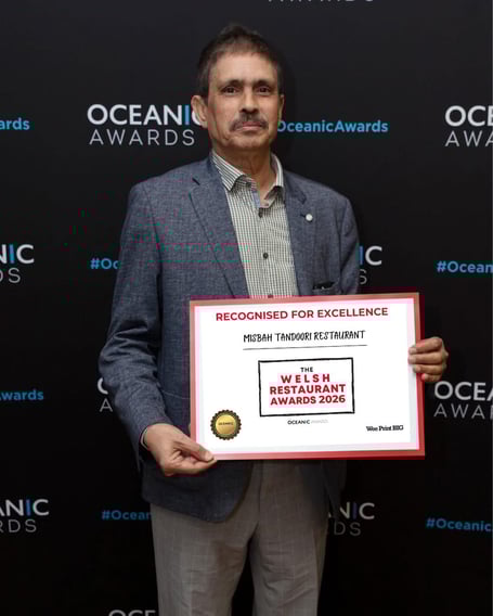 Dul Miah accepts the Welsh Restaurant Award for the Misbah