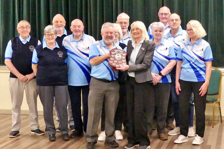 Dingestow captain Haydn Holder and players receive the League Trophy from MSMBA Chair, Philomena Vaughan. Photo: Colin Berg