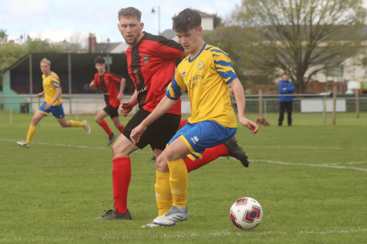 Close control under pressure from a Monmouth player