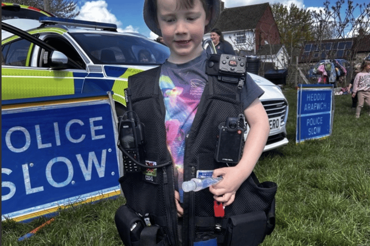 Trying on police officers jacket at Mathern Day Nursery celebration 