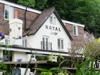 Riverside hotel hit by falling boulder from rock face