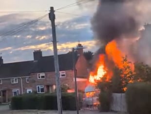 Man held over suspected arson after caravan blaze 