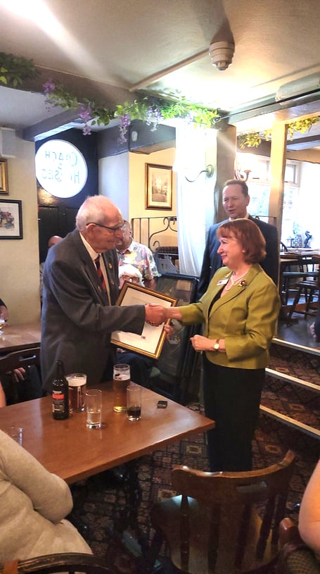 John Duke is congratulated on his award by Lynda Atkins.