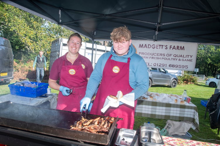 Emily Ruck and Fin Garside preparing meat on the Madgetts of St Briavels stand.